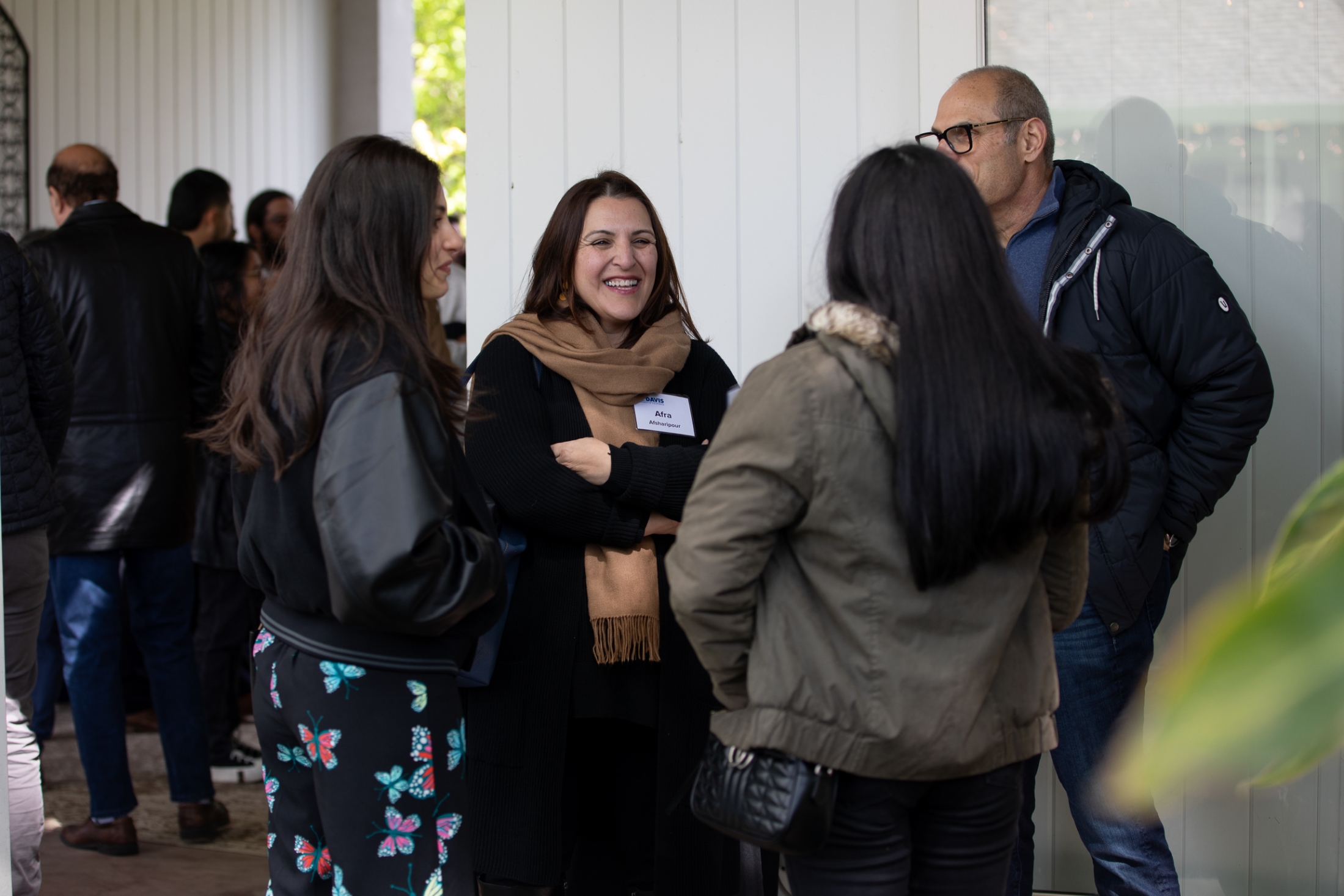 People mingling at the Chancellor's Residence for Admitted Students Weekend.