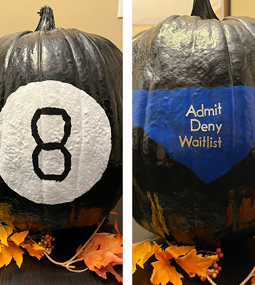 A pumpkin decorated as a Magic 8 Ball.