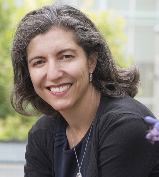 Professor Chimene Kietner sitting outside and smiling.