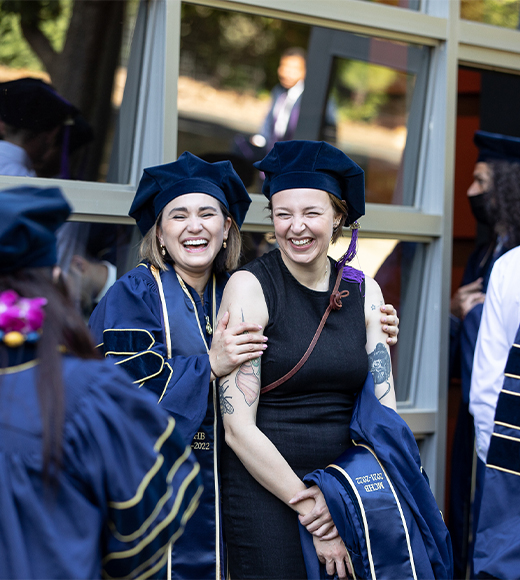 Two students from the UC Davis Law Class of 2022 posing for a photo on the day of Commencement.
