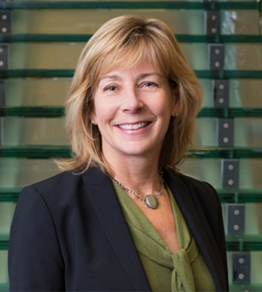 Karen Johnson-McKewan wearing a suit jacket and smiling at the camera.