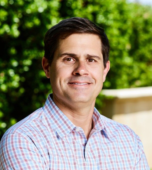 Matt Tolve wearing a button-down and smiling at the camera.