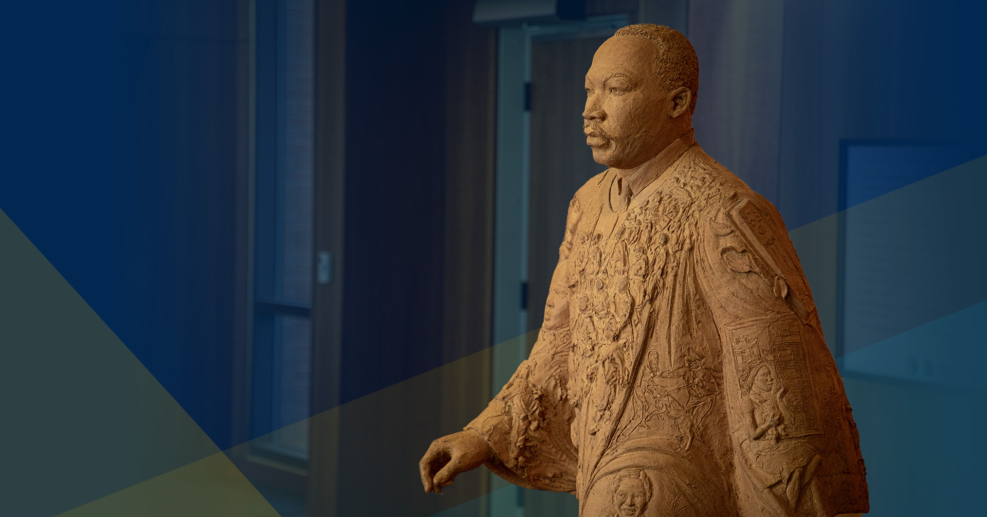 A statue of Martin Luther King, Jr. over a blue background.