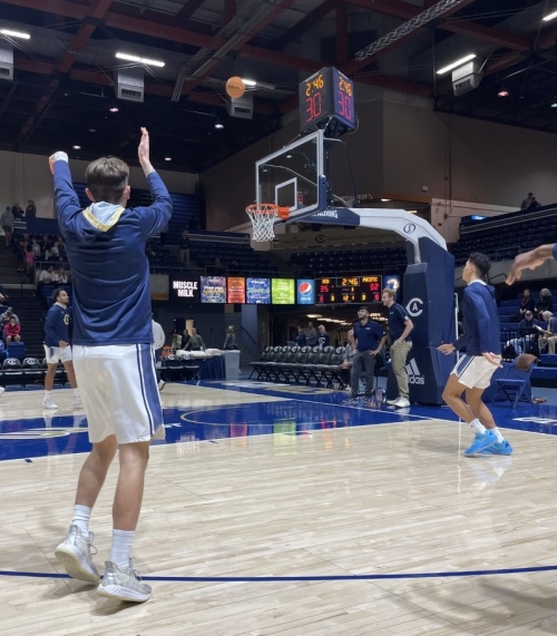 A UC Davis men's basketball player takes a shot during warm-ups. 