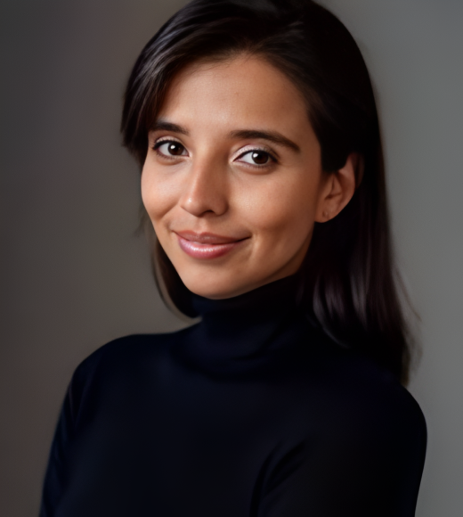 Portrait of a smiling woman with long dark hair, wearing a black turtleneck.