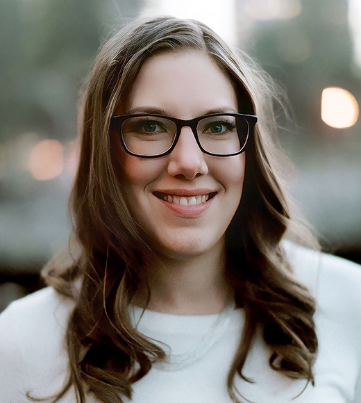 UC Davis Law Lecturer Nina Jehle wearing glasses and smiling at the camera.