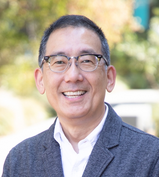 UC Davis Law Professor Thomas Joo wearing a suit and smiling at the camera.