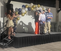 A graduating student receiving an honor at the Filipinx LSA Banquet.
